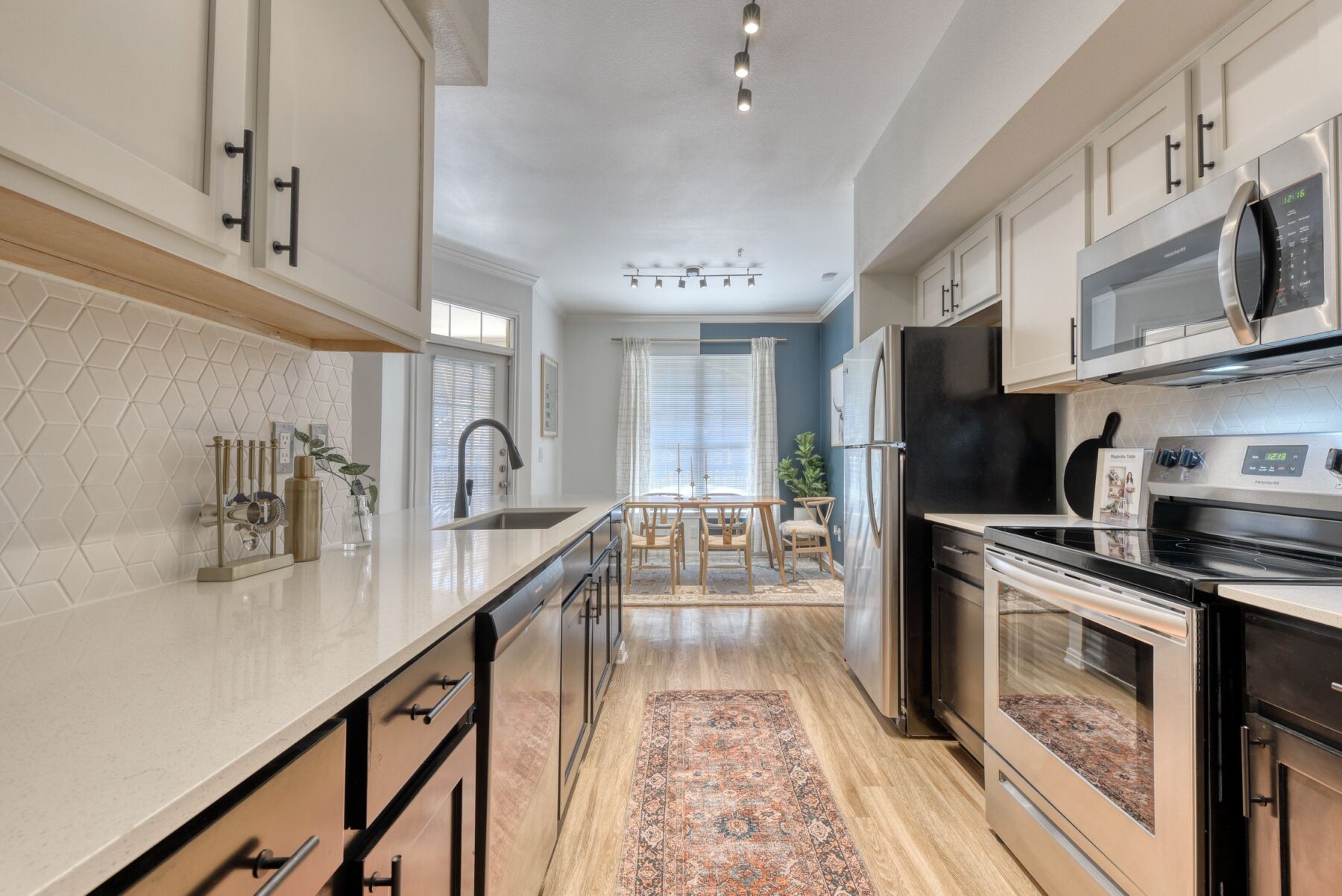 Kitchen with stainless steel appliances and tile backsplash