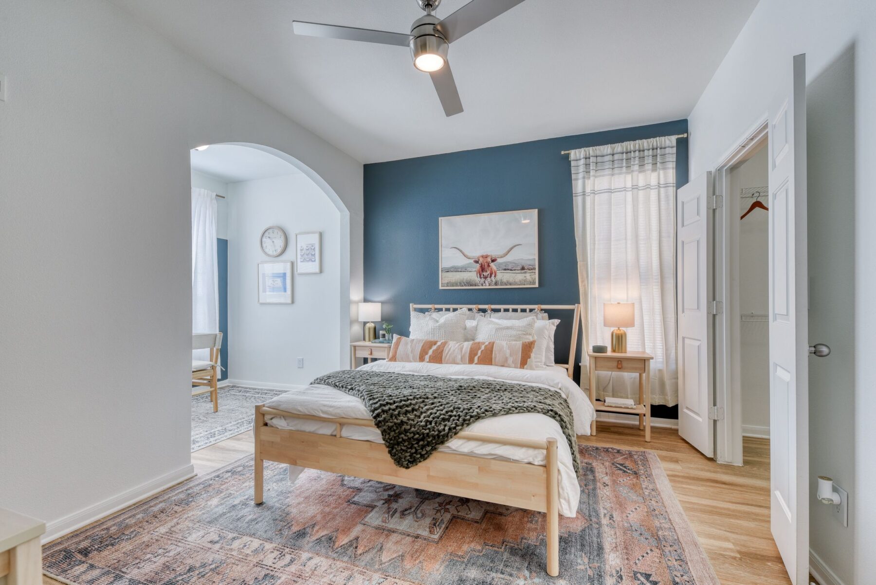 bedroom with sitting area and blue accent wall