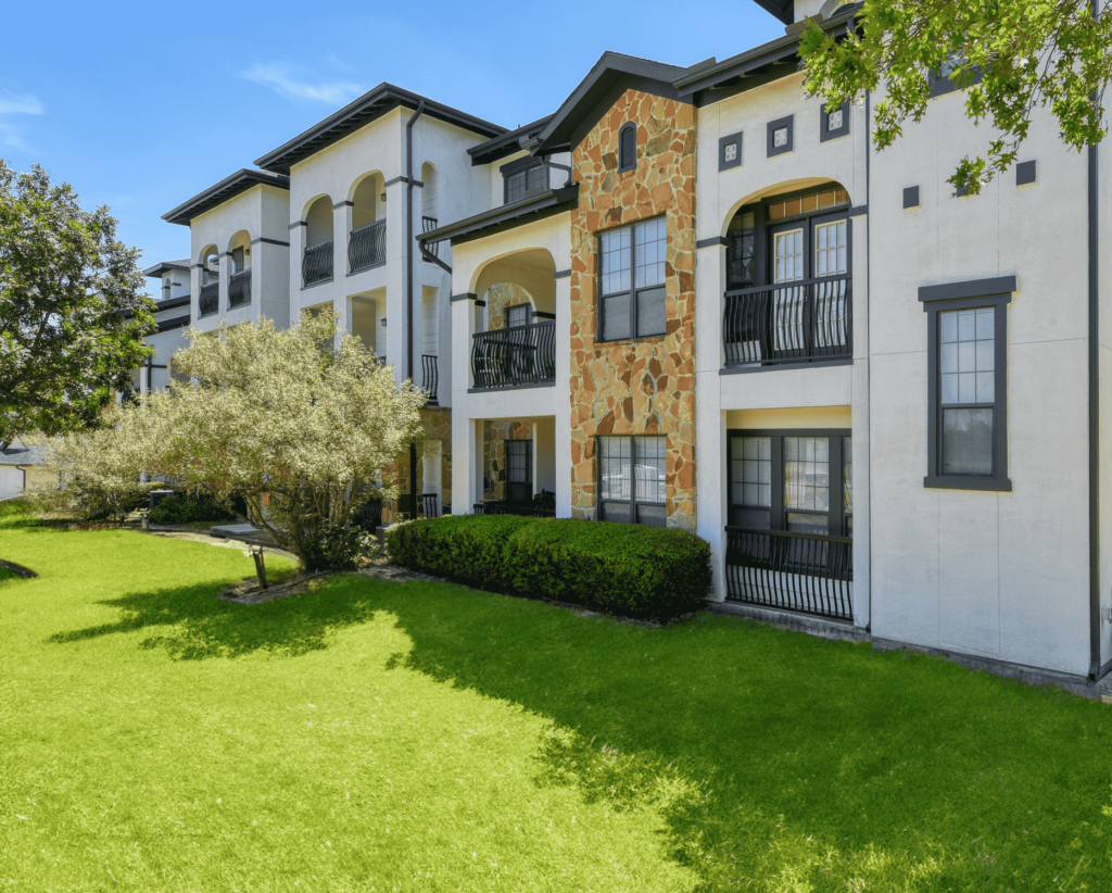 Building exterior with private balconies and large trees