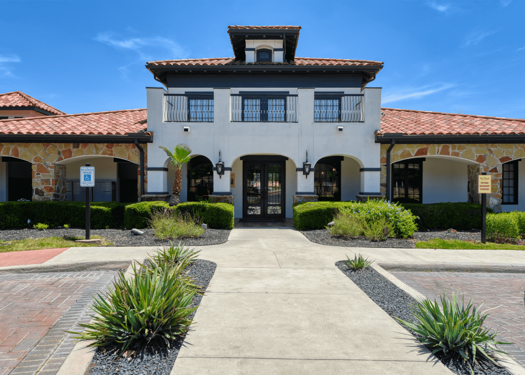 leasing office exterior, lots of landscaping and large windows