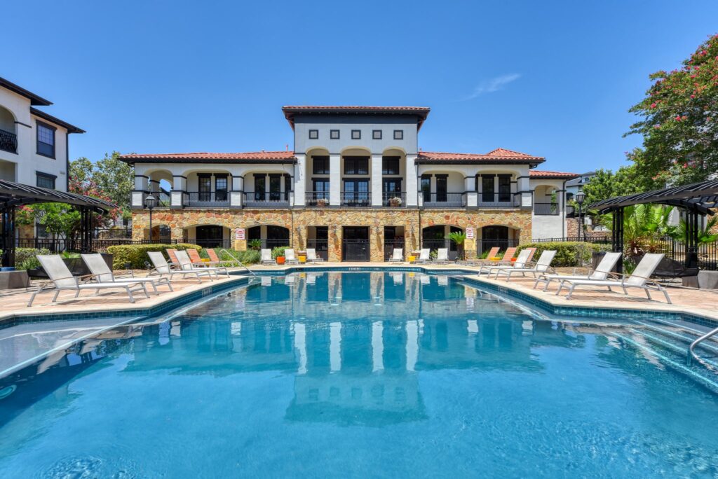 Lush pool with shaded pavilion at the San Miguel apartments near The RIM in San Antonio