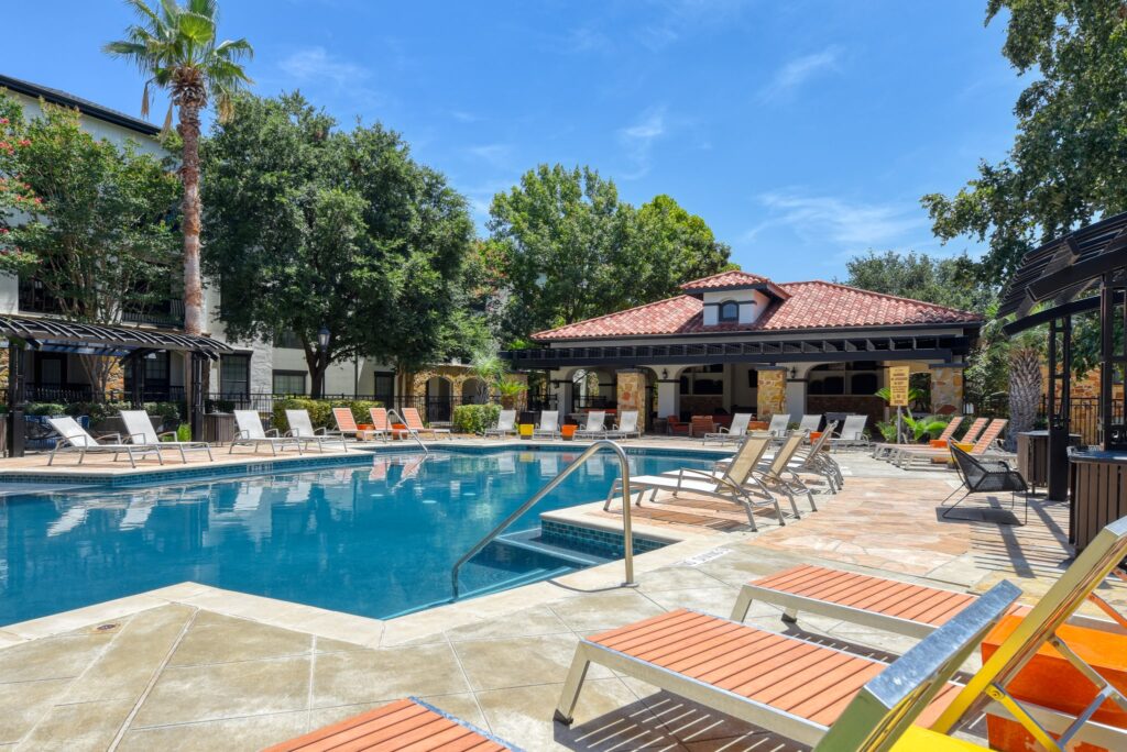 Relaxing pool with lounge chairs at the San Miguel apartment homes in San Antonio